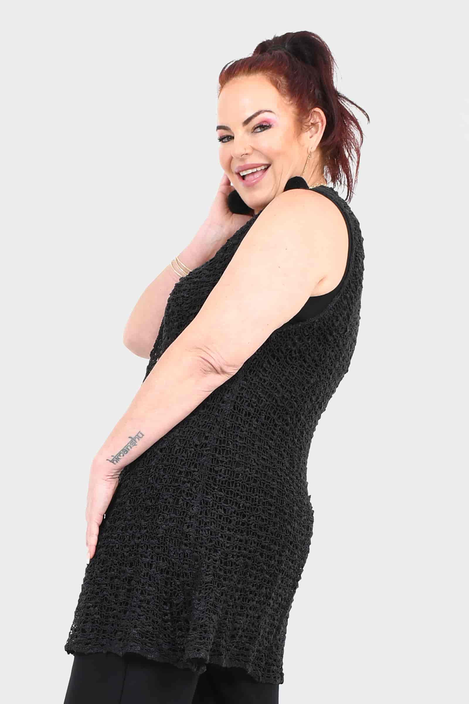 Black sleeveless popcorn vest, side view, textured knit with open front