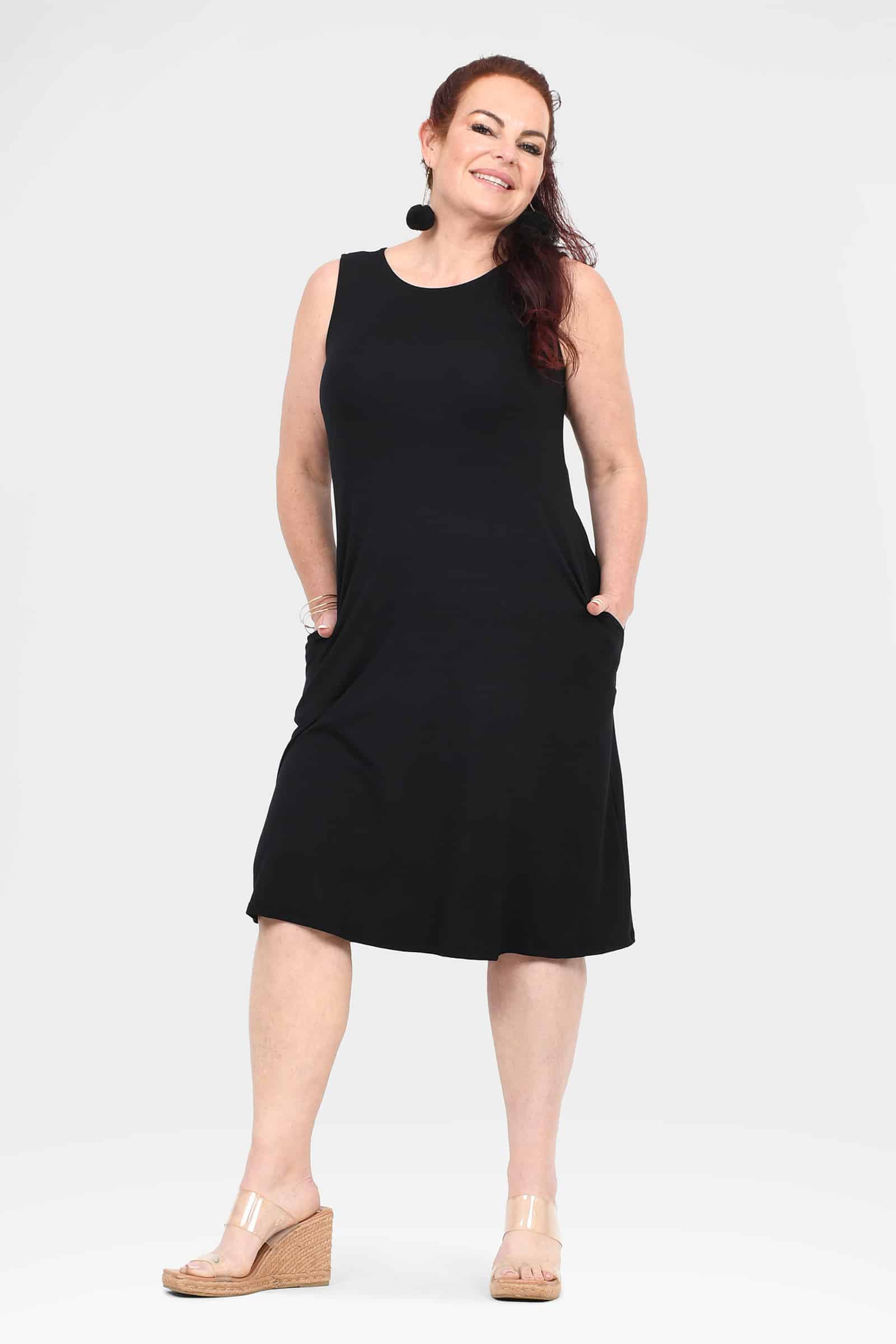 Black sleeveless shift dress with round neck and above-knee length