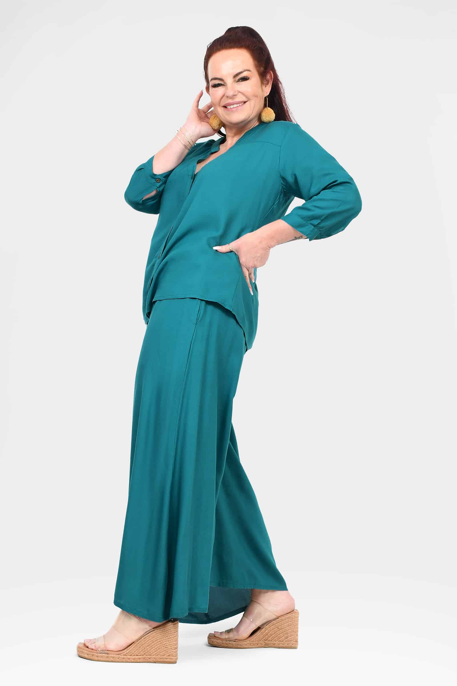 Teal palazzo pants with flowing wide legs and comfortable draped fit