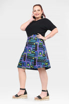 Reversible button skirt with black yoke and teal, purple, and green geometric print
