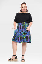 Reversible button skirt, black upper and teal-purple abstract print, side pocket flaps