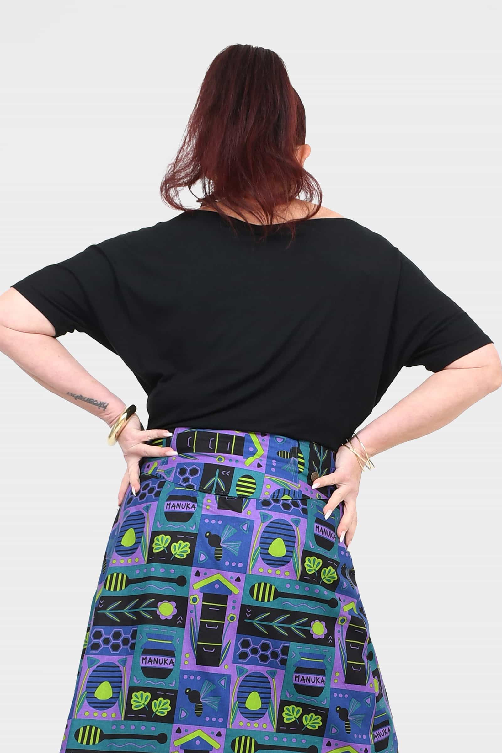 Black short-sleeve top, back view, relaxed drape and wide neckline