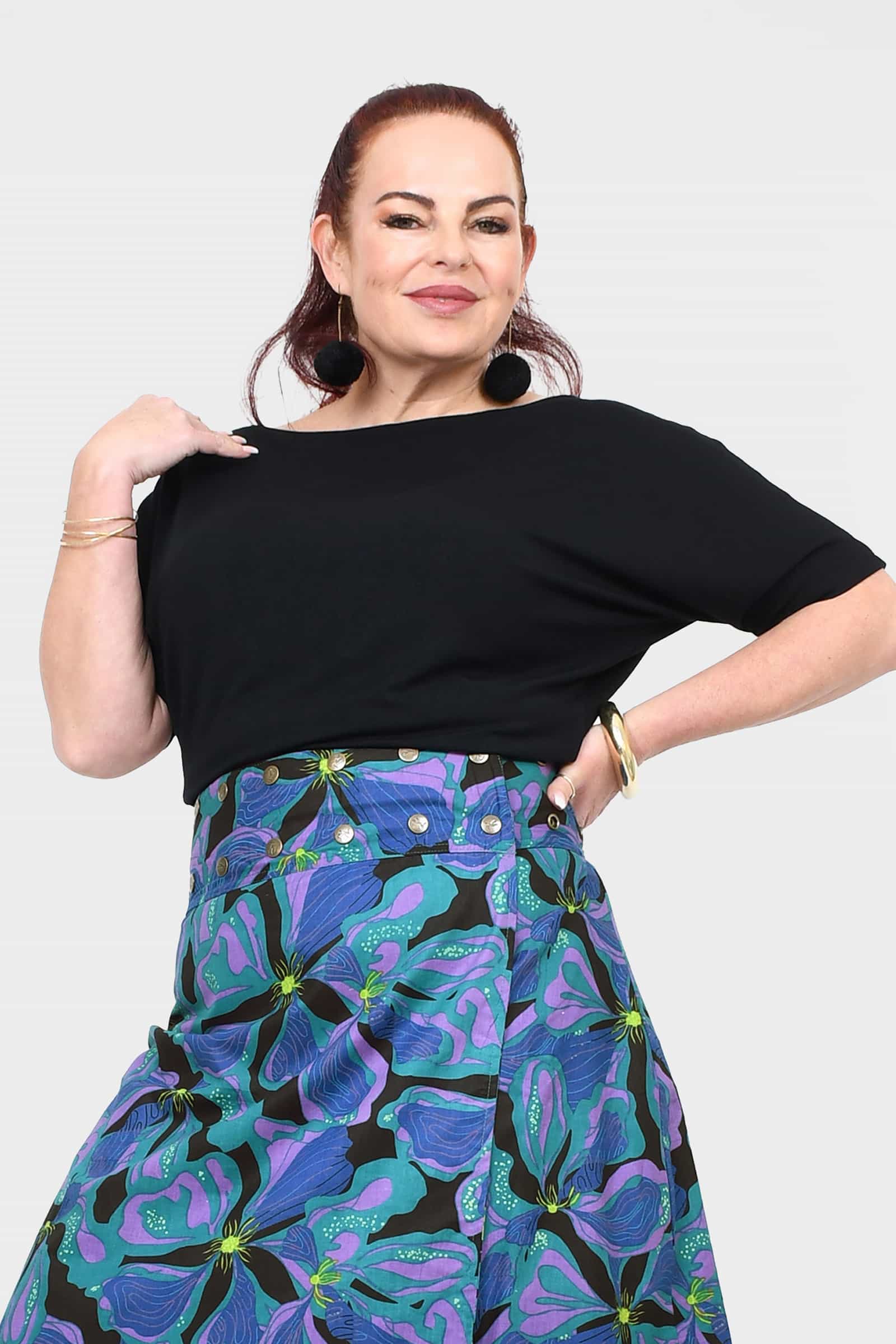Black short-sleeve top with loose drape and wide neckline detail at shoulders