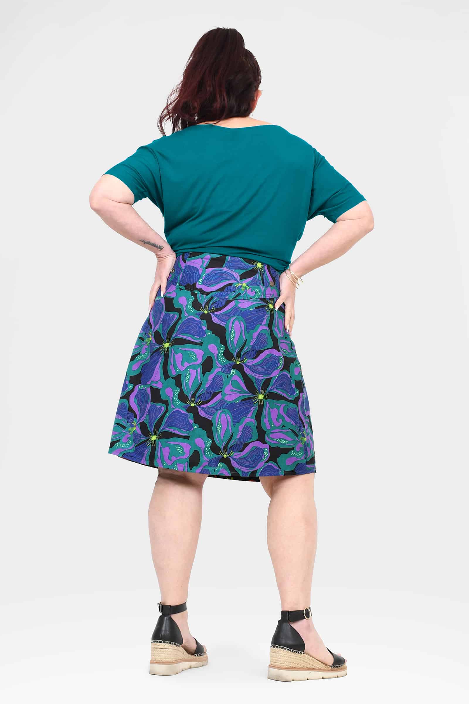 Long reversible button skirt, back view with purple and teal tropical print