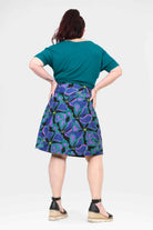 Long reversible button skirt, back view with purple and teal tropical print