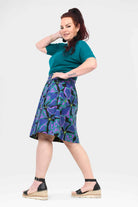 Long reversible button skirt in purple and teal tropical print, side view