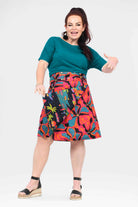 Above-knee A-line skirt in multicolor abstract floral print with dark waistband