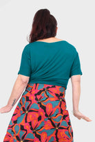 Back view of dark teal short-sleeve crew-neck top with relaxed drape