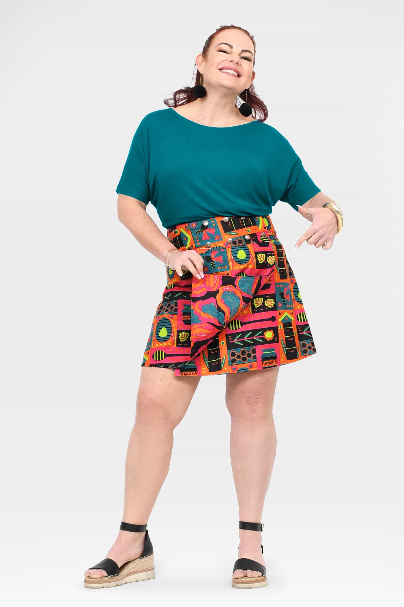 Reversible short graphic skirt in teal, orange, and pink, flared fit