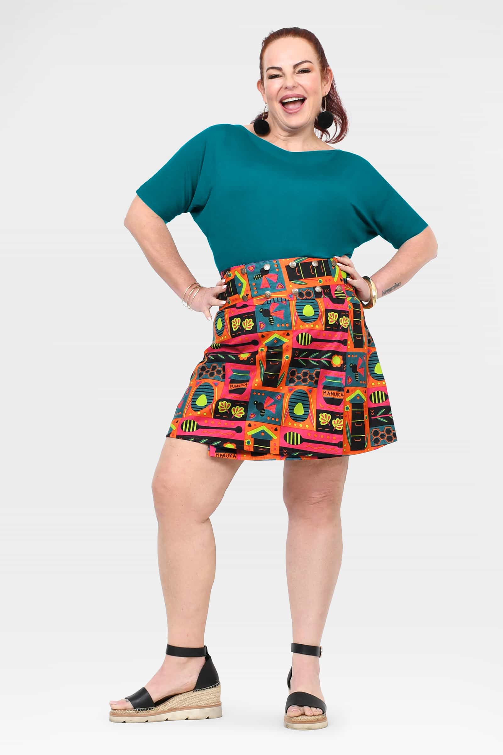 Flared short skirt with teal panel and bold multi-color graphic print