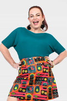 Dark teal short-sleeve top with round neckline and relaxed drape fit
