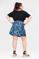 Reversible short button skirt, teal and purple botanical print with black reverse panel