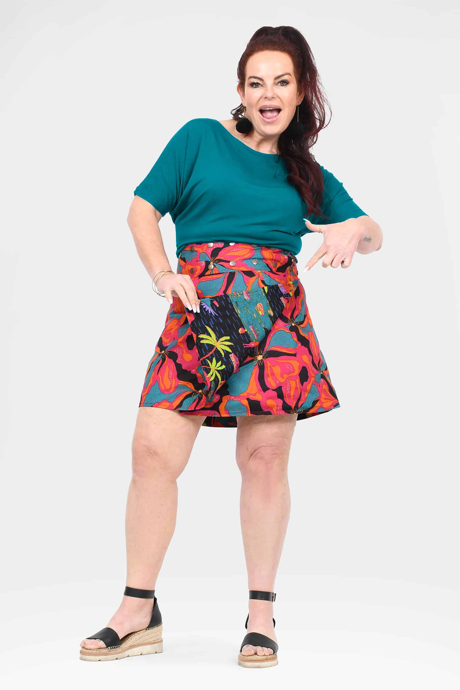 Reversible button short skirt with bright pink and orange floral pattern