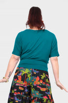 Dark teal short-sleeve top from behind with round neckline, relaxed fit
