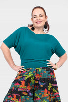 Dark teal short-sleeve top with round neckline, gathered waist seam detail