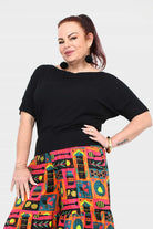 Black short-sleeve top with smooth relaxed fit and wide neckline at shoulder line