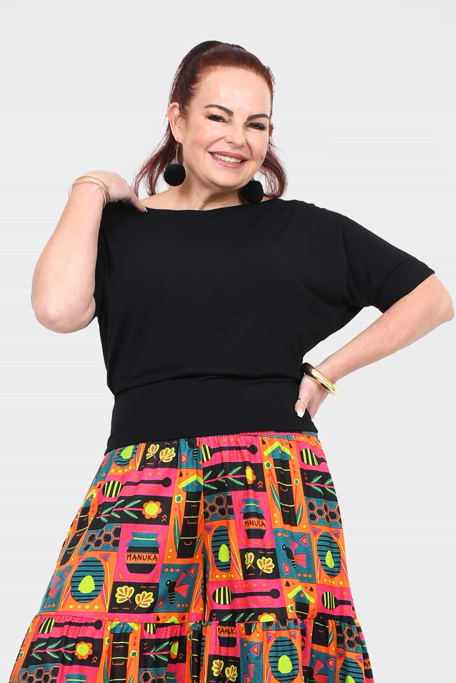 Black short-sleeve top with wide neckline and relaxed, draped fit