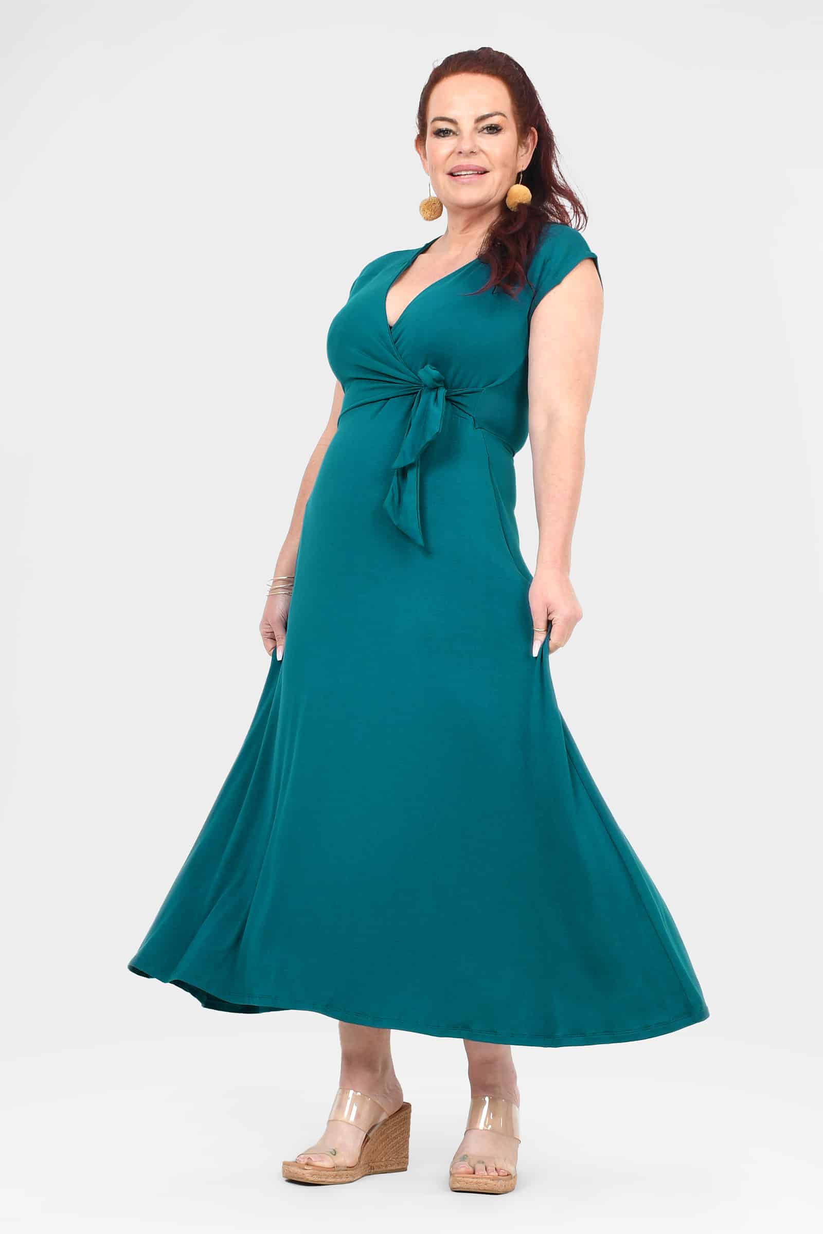 Dark teal sleeveless V-neck midi dress with tied waist and flared skirt