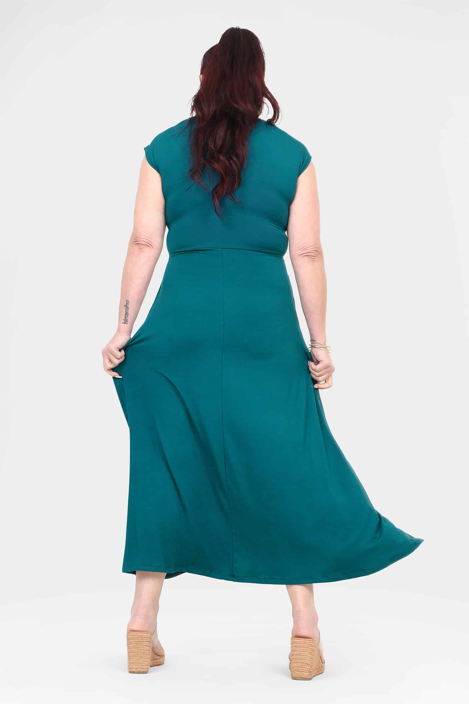 Back view of dark teal sleeveless V-neck midi dress with tie waist seam
