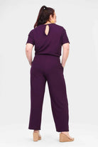 Women's aubergine jumpsuit back view with keyhole back, short sleeves, tie waist