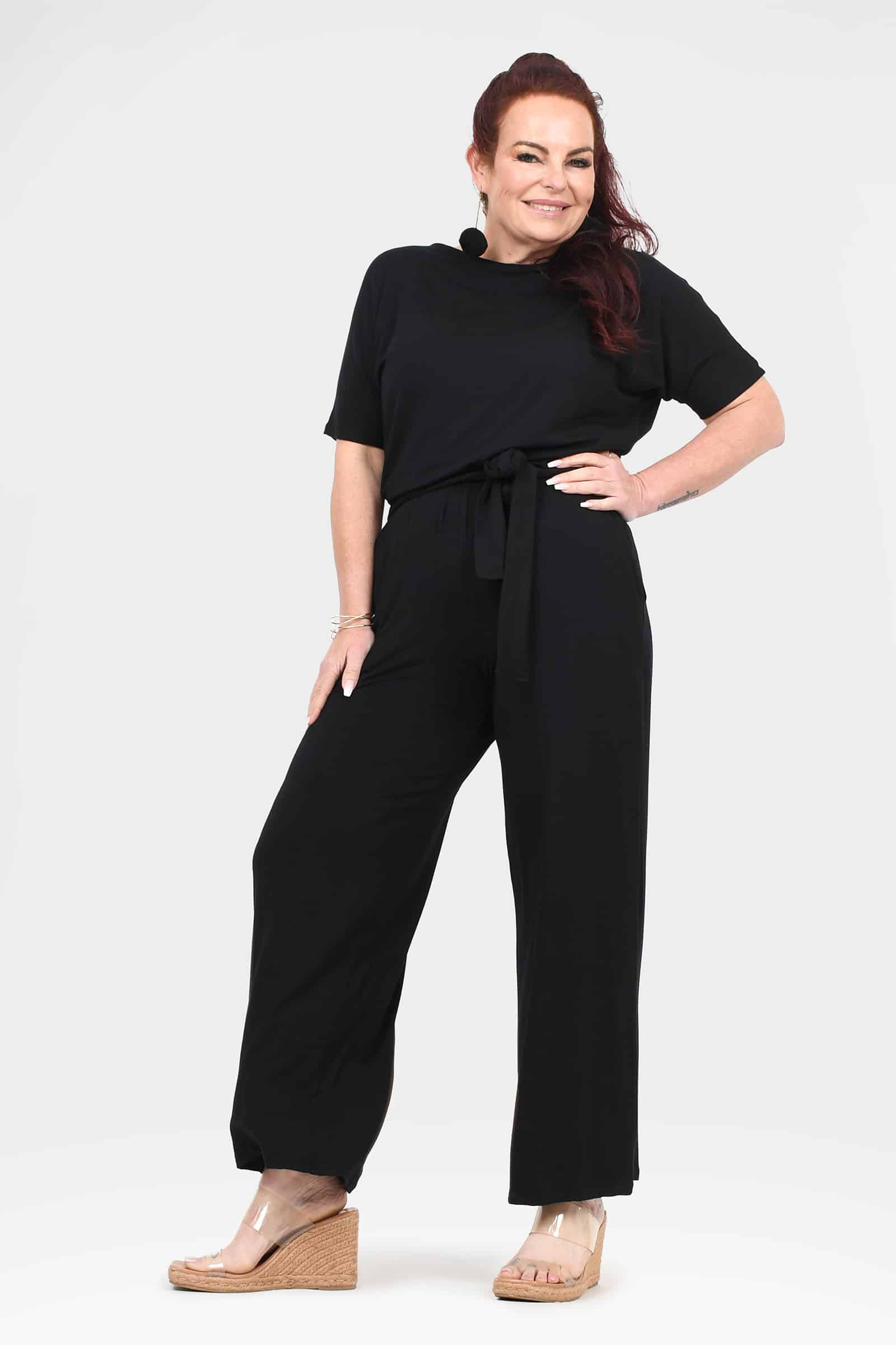 Black short-sleeve jumpsuit with tie waist and relaxed wide-leg fit