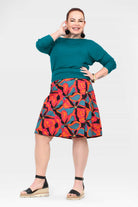 Long reversible button skirt with teal solid front and bold tropical floral graphic