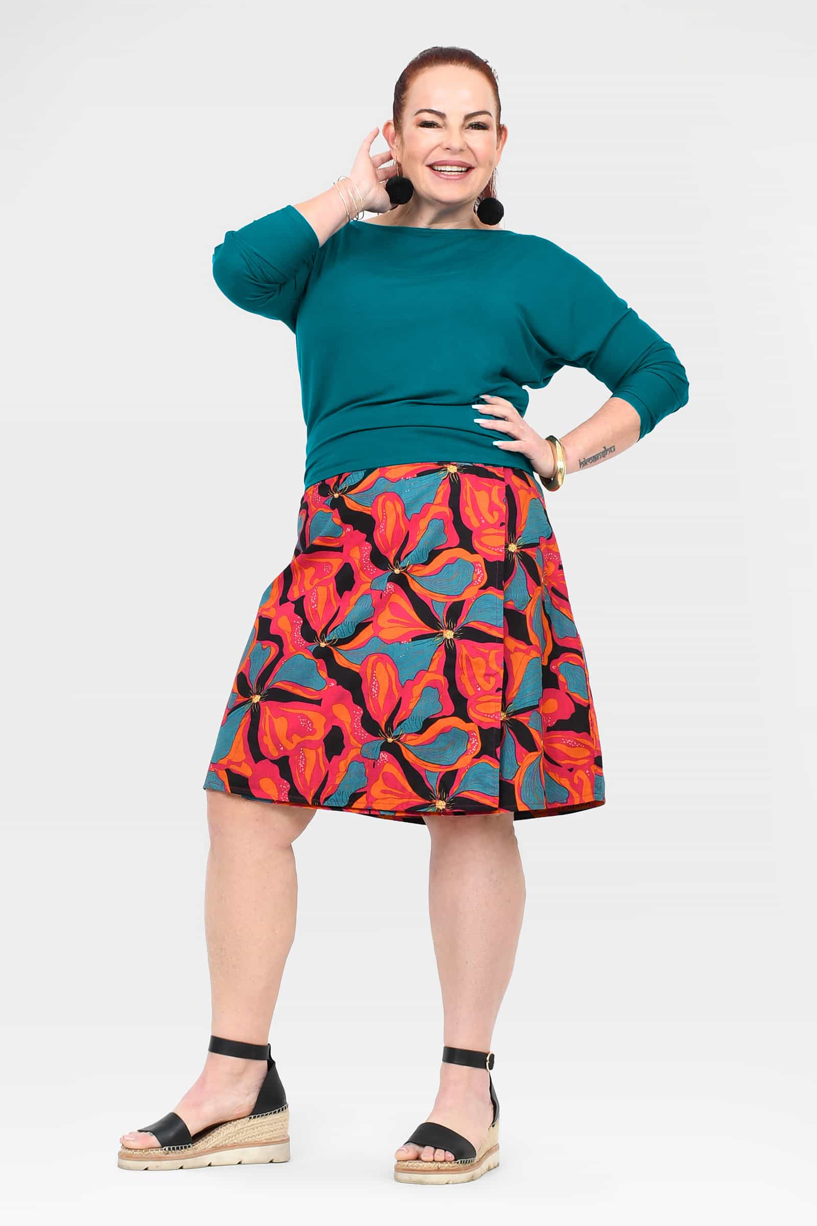 Long reversible button skirt with teal solid front and bold tropical floral graphic