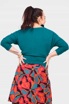 Dark teal crew-neck top with three-quarter sleeves and back seam detail