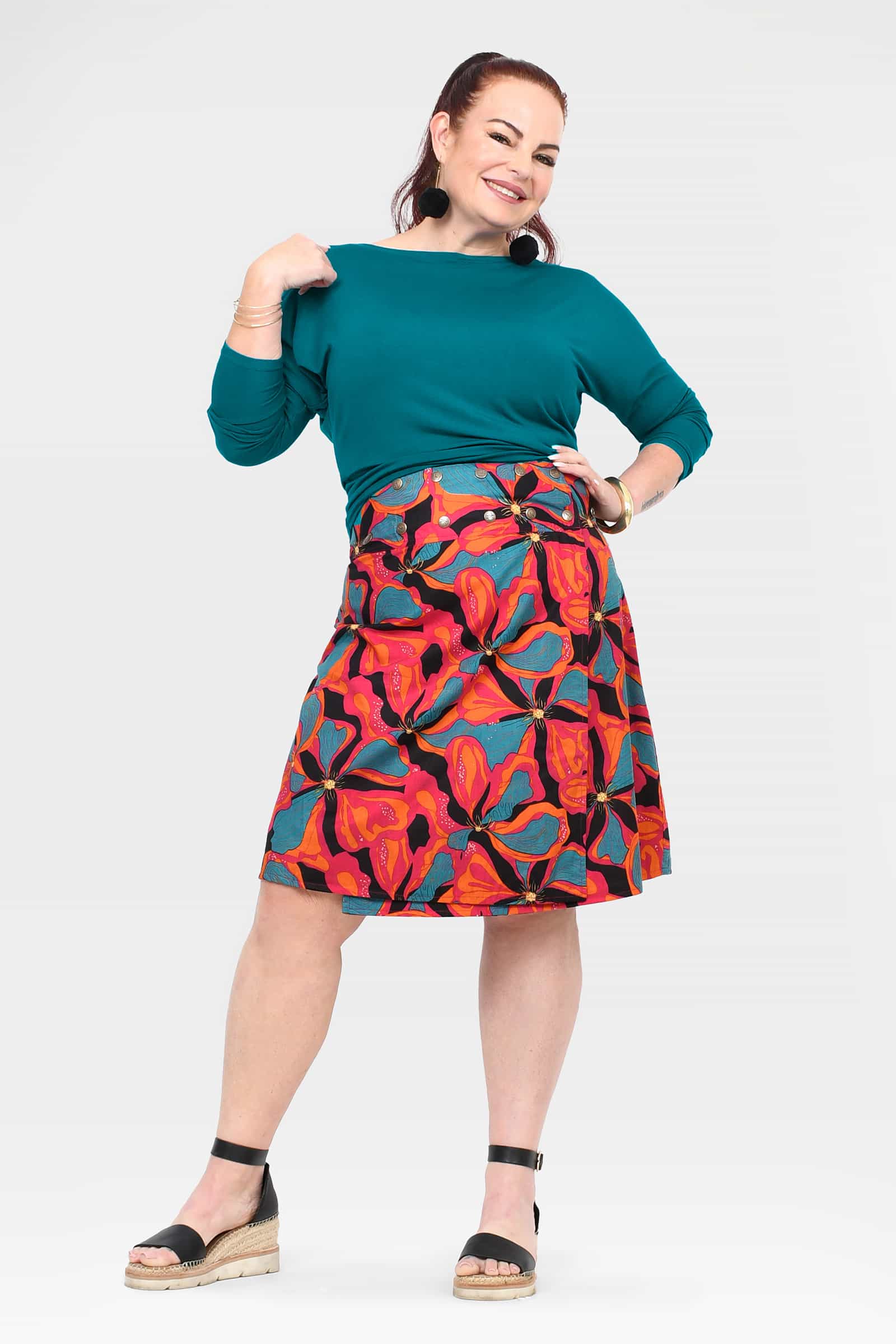 Long reversible button skirt with button front; teal top panel and tropical print hem