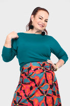 Dark teal crew-neck top with three-quarter sleeves and relaxed drape