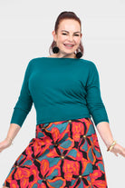 Dark teal crew-neck top with three-quarter sleeves and smooth front panel