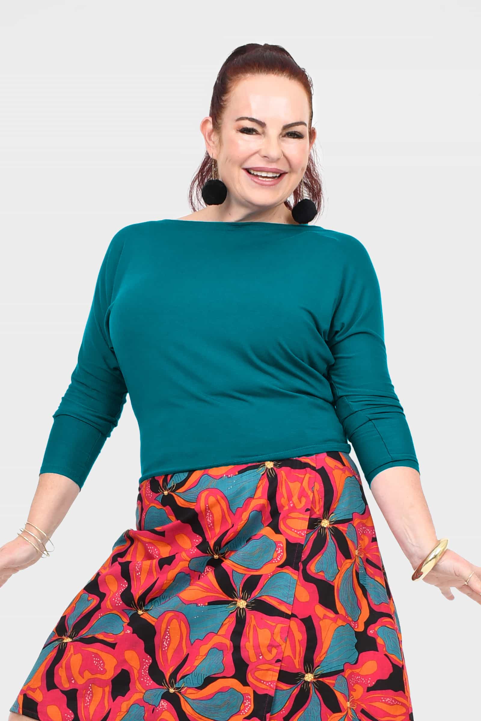 Dark teal crew-neck top with three-quarter sleeves and smooth front panel