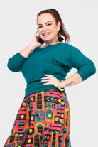 Dark teal crew-neck top with three-quarter sleeves and comfortable fit