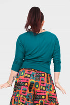 Dark teal crew-neck top with three-quarter sleeves and straight back seam