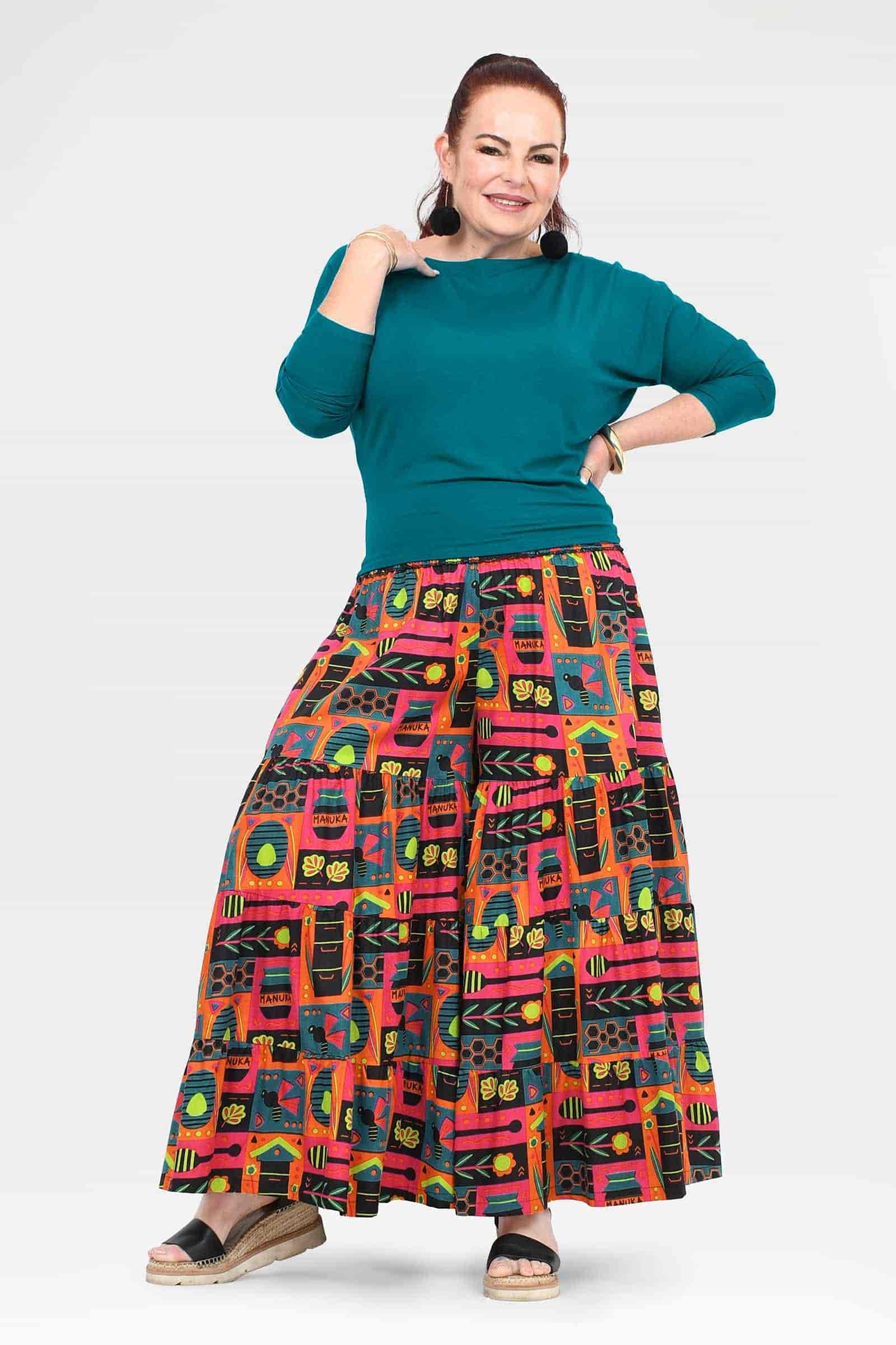 High-waist wide-leg pants with teal waistband and vibrant colorful graphic print