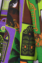 Colorful fabric with abstract patterns in green, purple, black, and orange.