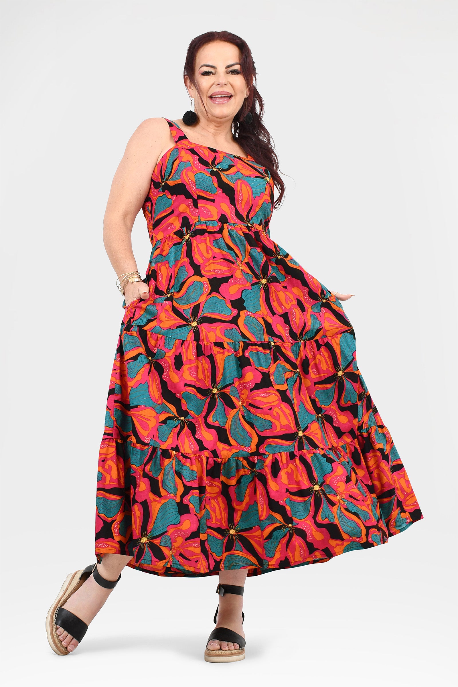 Sleeveless maxi dress with gathered bodice and tiered skirt in vibrant abstract floral print