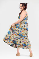 Multicolor tropical print sleeveless maxi dress, side view with flared hem