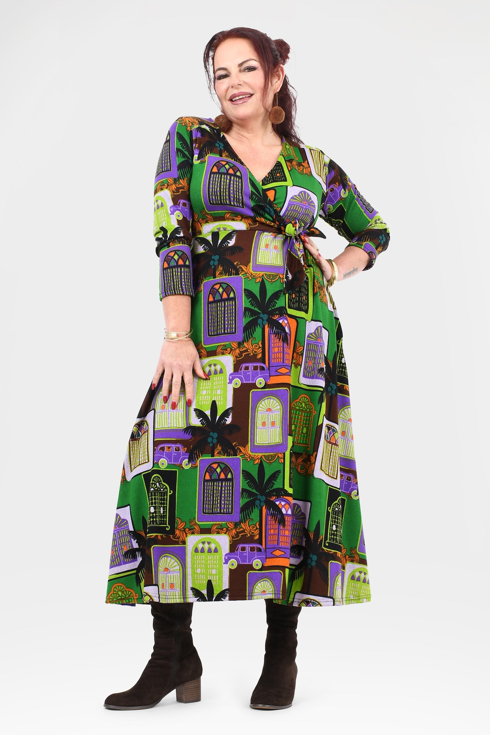 Woman wearing a patterned dress with a white background