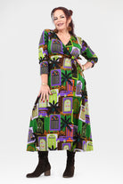Woman wearing a patterned dress with a white background
