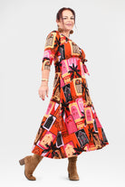 Woman wearing a colorful patterned dress on a white background