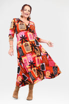 Woman wearing a colorful patterned dress on a white background