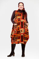 Woman wearing a patterned dress with a white background