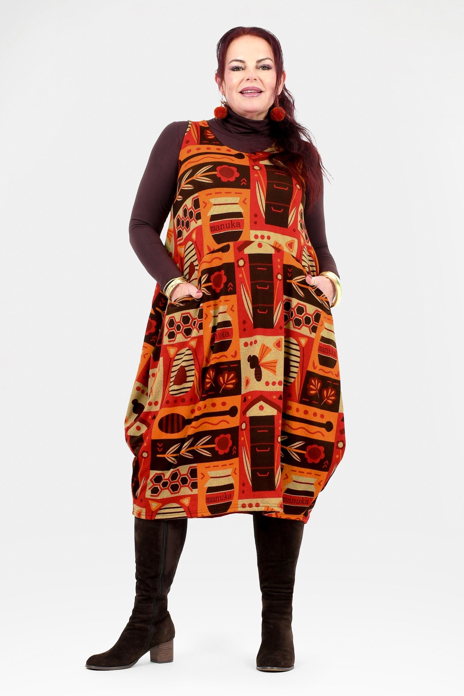 Woman wearing a patterned dress with a white background