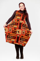Woman wearing a patterned dress with a plain background