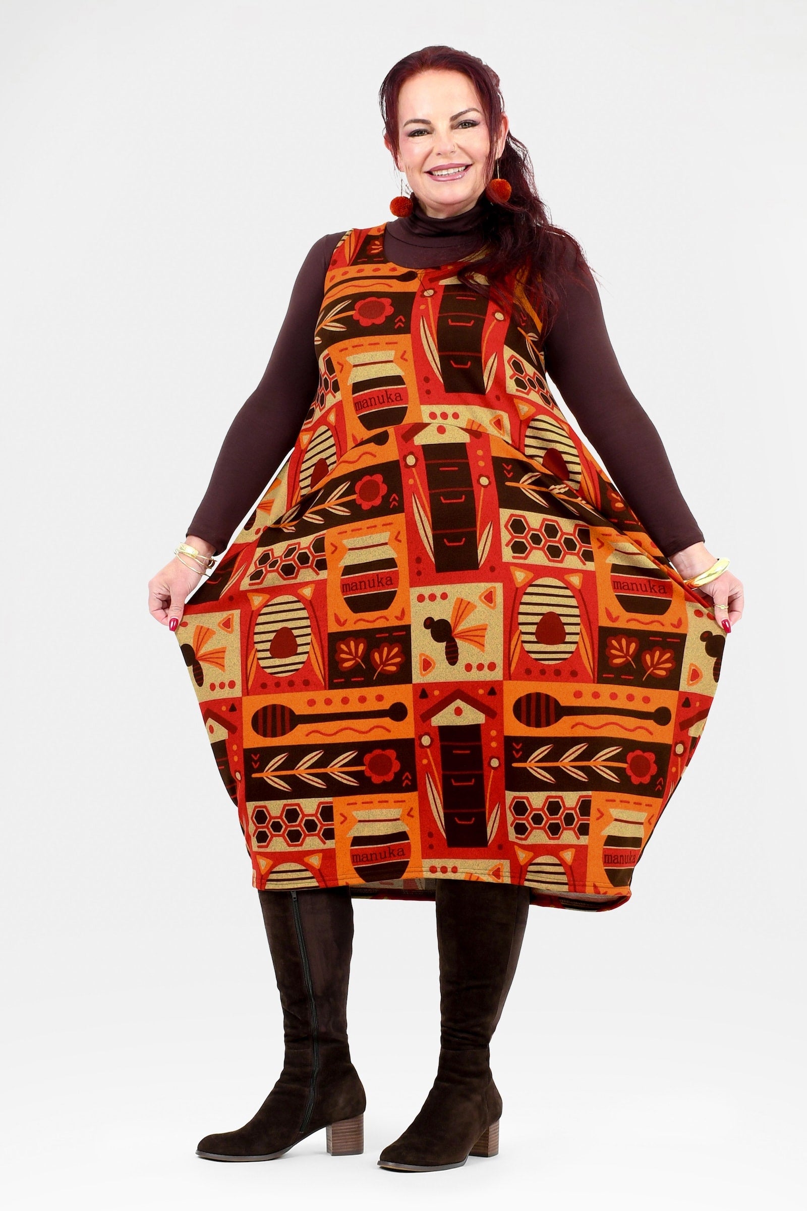 Woman wearing a patterned dress with a plain background