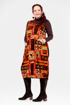 Woman wearing a patterned dress with a white background