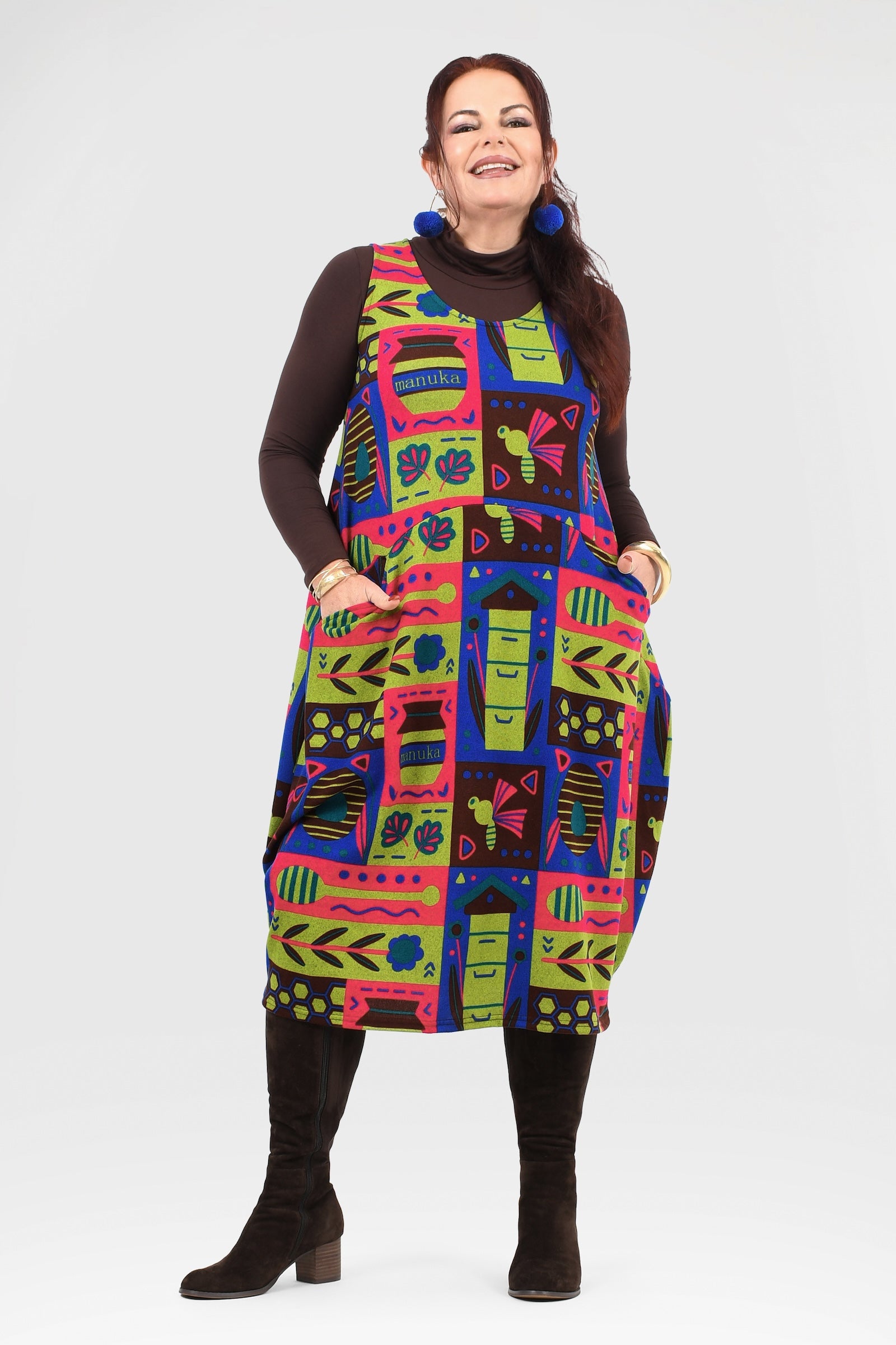 Woman wearing a colorful patterned dress on a white background