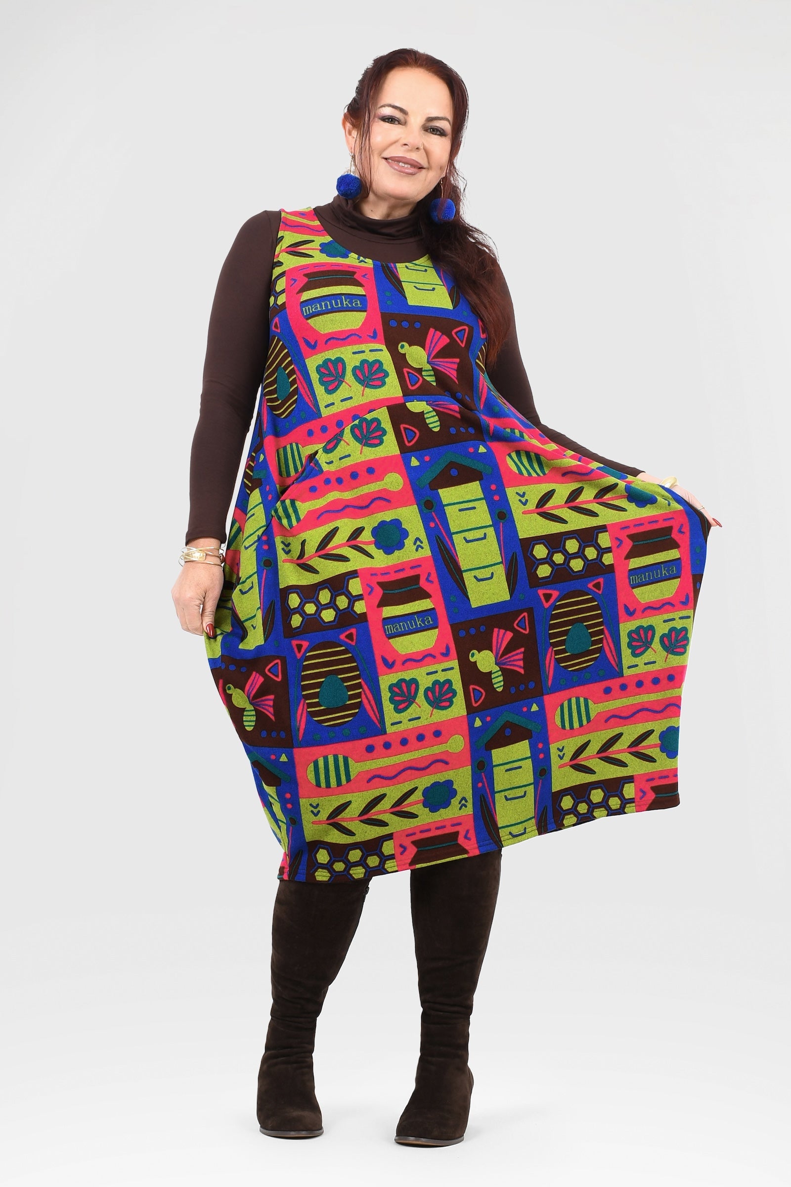 Woman wearing a colorful patterned dress on a white background