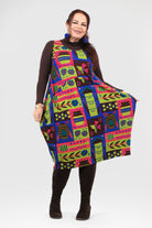 Woman wearing a colorful patterned dress on a white background